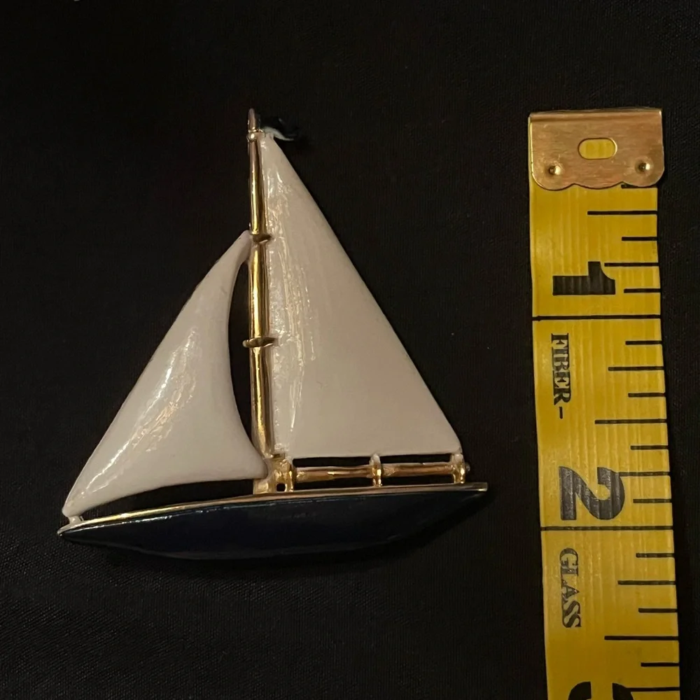 Gold tone sailboat brooch with white and blue enamel